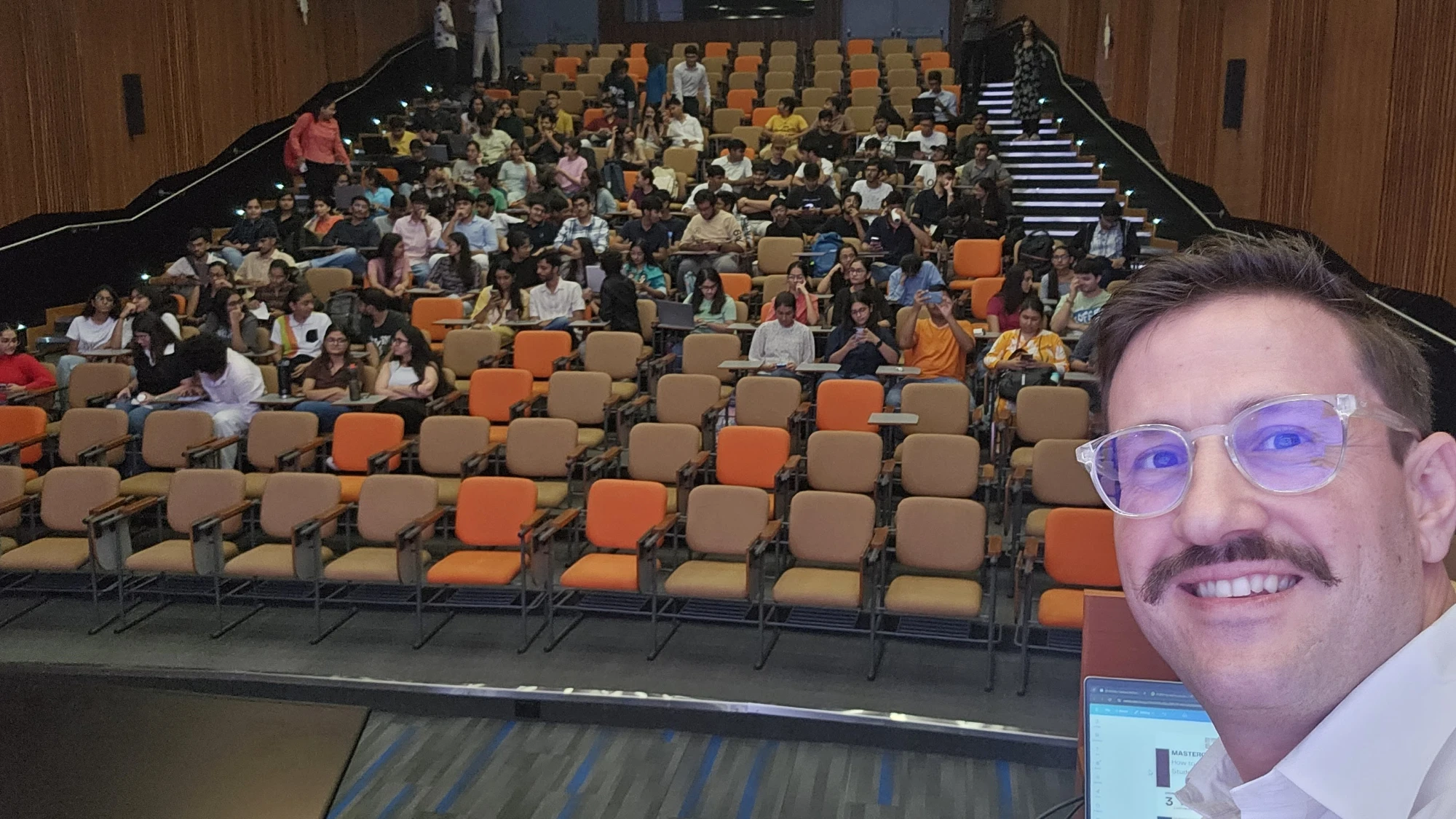 Jeremy Fritzhand addressing a full auditorium of students