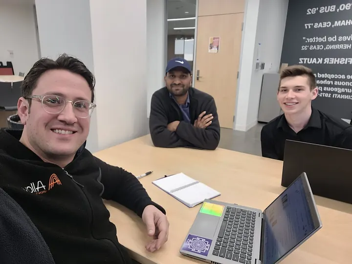 Jeremy Fritzhand at a working session with two founders around a table